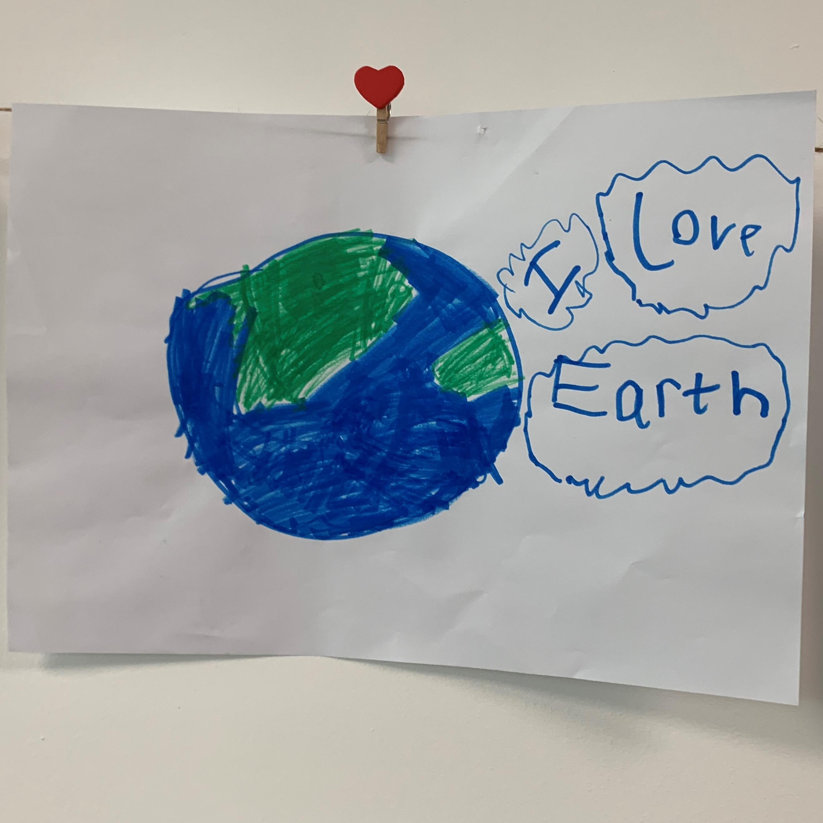 Childs drawing of a globe with &#039;I love earth&#039; to the right of it.